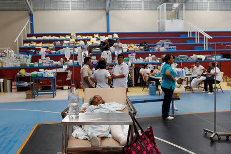 A patient lies down on a hospital bed in a provisional hospital on a basketball court after an earthquake that struck the southern coast of Mexico late on Thursday, in Juchitan, Mexico, September 9, 2017. REUTERS/Carlos Jasso