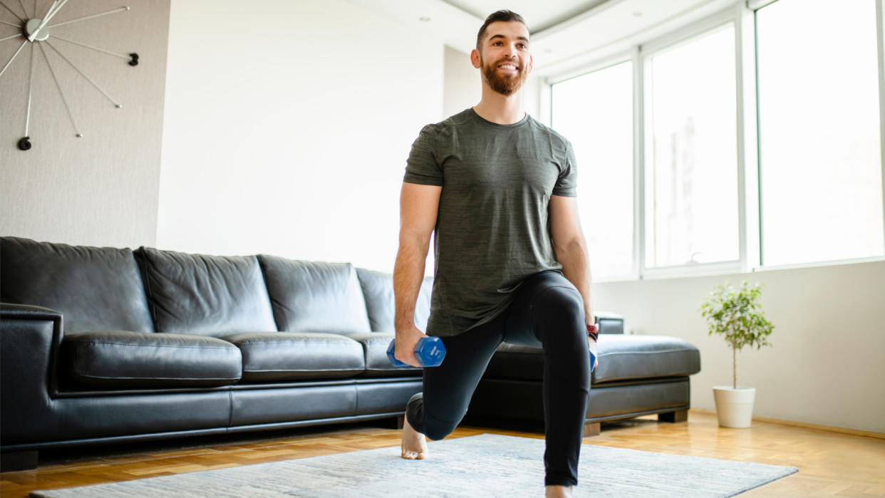  Man doing dumbbell lunges. 