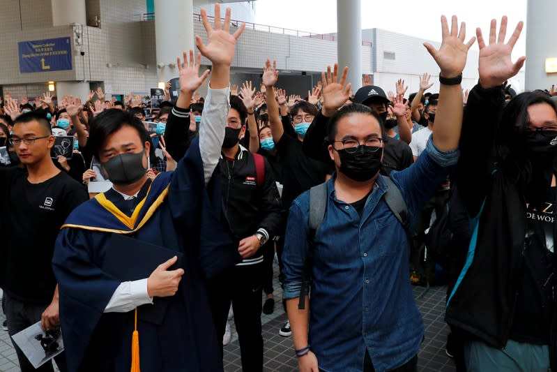 Graduates attend a ceremony to pay tribute to Chow Tsz-lok, 22, an university student who fell during protests at the weekend and died early on Friday morning, at the Hong Kong University of Science and Technology, in Hong Kong