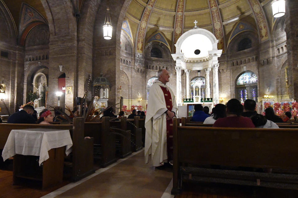 In this Jan. 24, 2020 photo, Father Kevin McDonough holds Mass at the Sagrado Corazon de Jesus church in Minneapolis for a two-day celebration for the patron saint of the Mexican town of Axochiapan and nearby villages in the state of Morelos. McDonough began his homily by telling the several hundred faithful present that his counterpart in Axochiapan had phoned to wish them a happy holiday. (AP Photo/Jim Mone)