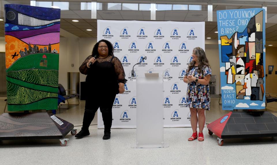 Artists Jessica Travis of Akron and Tracy Dawn Brewer of Stark County talk about the inspiration behind their work during the unveiling of Wing Art at the Akron-Canton Airport.