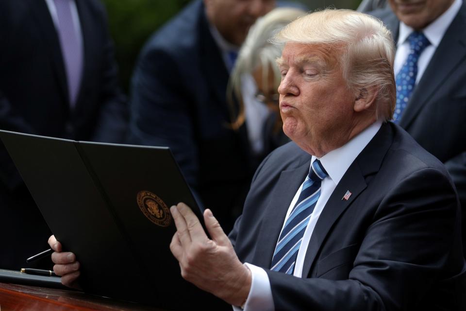 <p>President Trump prepares to sign an Executive Order on Promoting Free Speech and Religious Liberty during the National Day of Prayer event at the White House in Washington, D.C., on May 4, 2017. (Photo: Carlos Barria/Reuters) </p>