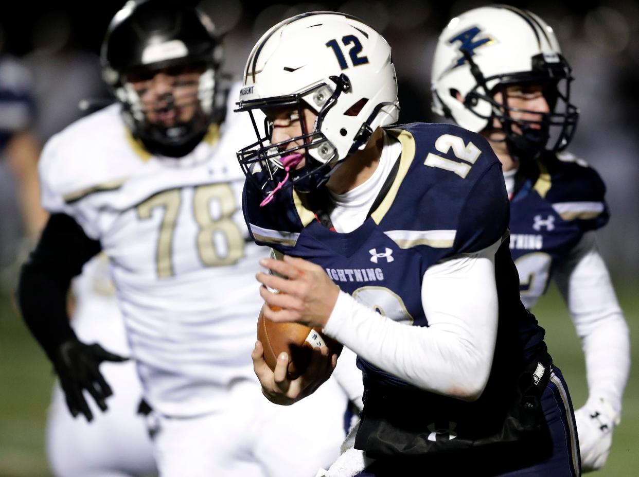 Appleton North quarterback Matthew Schecklman (12) rushes for a second-quarter touchdown against Franklin during their WIAA Division 1 state semifinal football game Friday at Titan Stadium in Oshkosh.