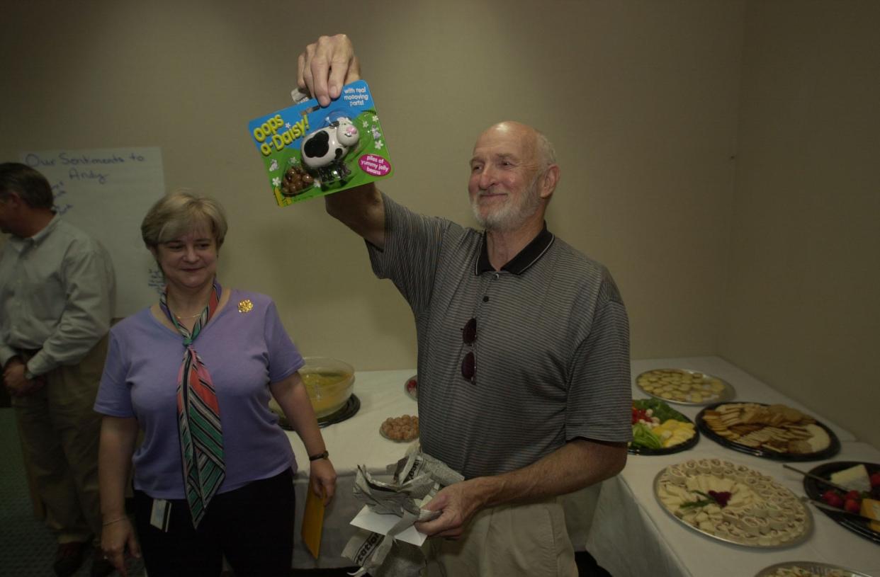 StarNews Executive Editor Charles Anderson shows off a jelly bean dispensing cow during his retirement party at the StarNews in 2001. Anderson passed away on May 7 at age 84.