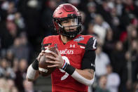 Cincinnati quarterback Desmond Ridder (9) looks to pass from the pocket during the first half of the American Athletic Conference championship NCAA college football game against Houston Saturday, Dec. 4, 2021, in Cincinnati. (AP Photo/Jeff Dean)