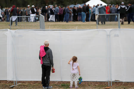 People attend the burial ceremony for the victims of the mosque attacks at the Memorial Park Cemetery in Christchurch, New Zealand March 21, 2019. REUTERS/Jorge Silva