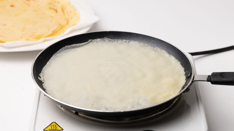 cooking crepes in a pan