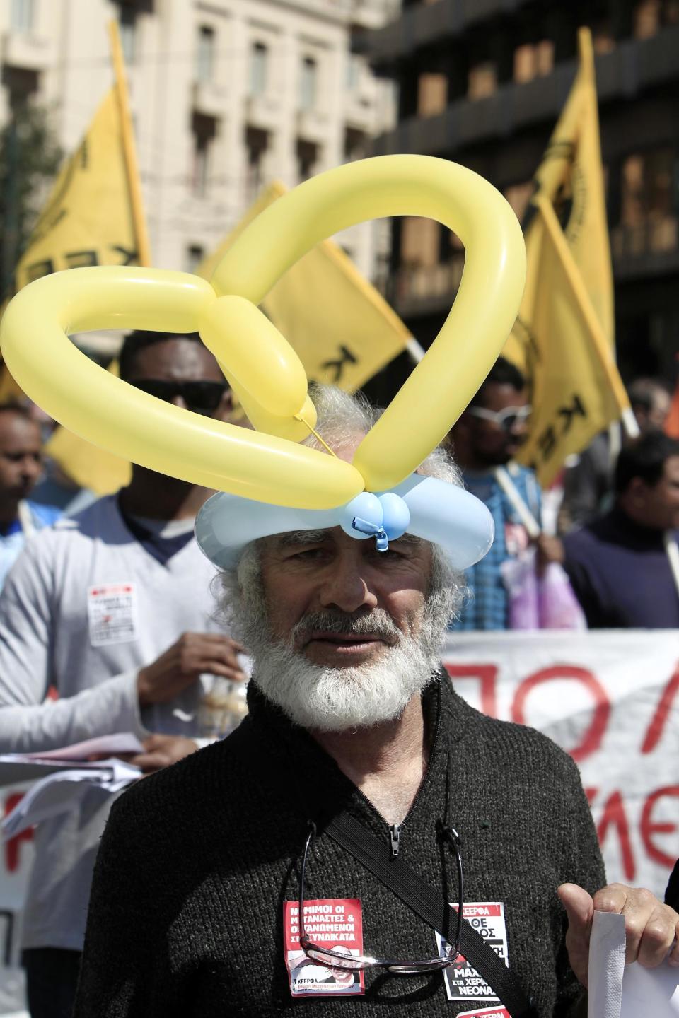 A protester takes part in a rally during a 24-hour strike in Athens, Wednesday, April 9, 2014. Unions say they are seeking an end to the painful savings policies that successive governments imposed to secure international bailout loans after Greece nearly went bankrupt in 2010. The repeated income cuts and tax hikes deepened a six-year recession, while unemployment has reached a record 28 percent. (AP Photo/Thanassis Stavrakis)