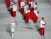 China's flag-bearer Tong Jian leads his country's contingent during the athletes' parade at the opening ceremony of the 2014 Sochi Winter Olympics, February 7, 2014. REUTERS/Lucy Nicholson