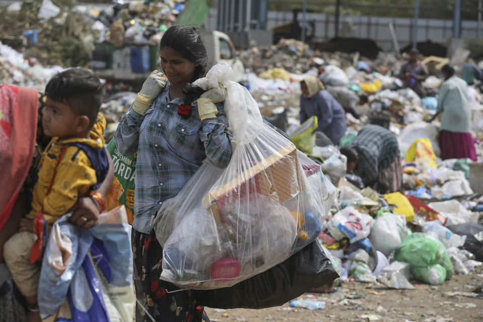 Ragpickers collect reusable material at a garbage dump in Hyderabad, India, on June 4, 2022.<span class="copyright">Mahesh Kumar—AP</span>