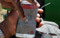 A mobile phone application shows movements of a John Deere 5503 tractor, installed with the Hello Tractor technology that connects farmers with vehicles' owners, in Umande village in Nanyuki