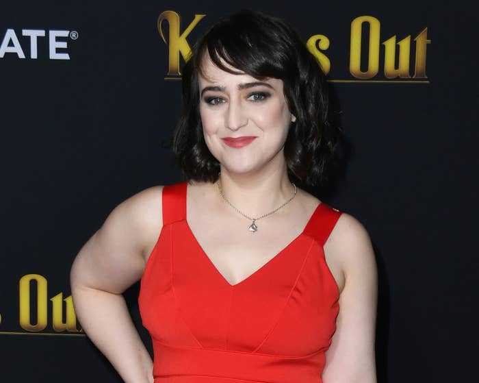 Mara wears a red dress while attending a premiere