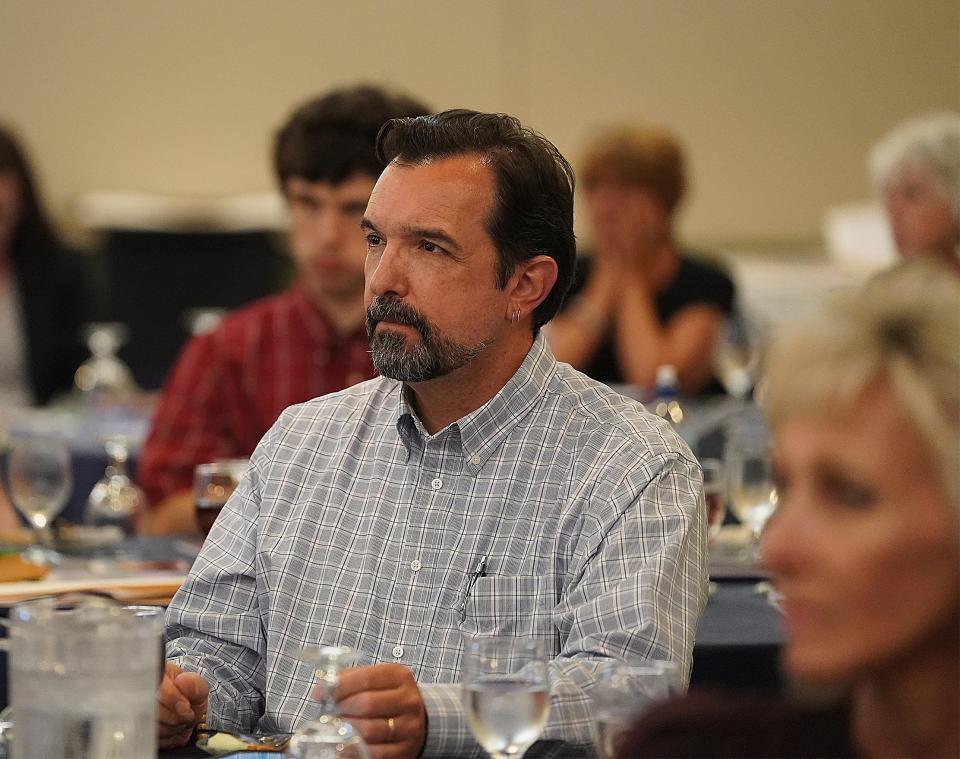 From left, Taunton City Councilor Barry Sanders and Mayor Shaunna O'Connell listen to speakers at a Bristol County Regional Coalition for Suicide Prevention conference held at the former Holiday Inn in Taunton on July 15, 2019.