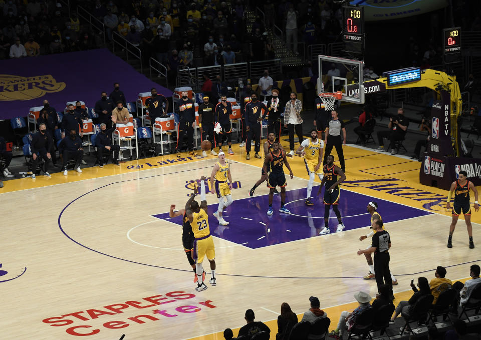 LeBron James #23 of the Los Angeles Lakers scores the game winning three point basket against Stephen Curry #30 of the Golden State Warriors in the closing minute of an NBA Tournament Play-In game at Staples Center on May 19, 2021 in Los Angeles, California. NOTE TO USER: User expressly acknowledges and agrees that, by downloading and or using this photograph, User is consenting to the terms and conditions of the Getty Images License Agreement. (Photo by Kevork Djansezian/Getty Images)