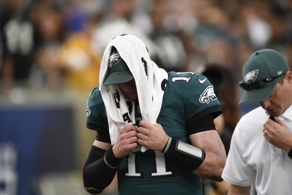 Philadelphia Eagles quarterback Carson Wentz leaves the field after suffering a knee injury in Week 14. (AP)