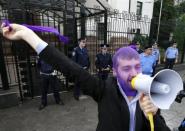 A supporter of the female punk band "Pussy Riot" shouts slogans during a gathering outside the Russian embassy in Kiev, August 17, 2012.