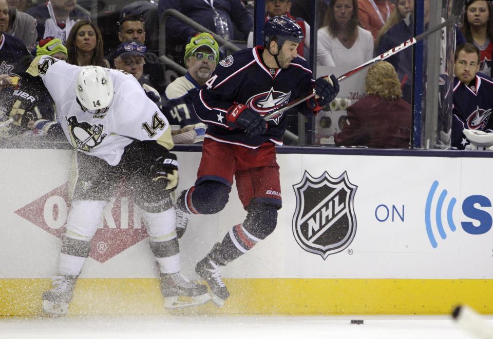 Columbus Blue Jackets' Derek MacKenzie, right, checks Pittsburgh Penguins' Chris Kunitz away from the puck during the second period of a first-round NHL playoff hockey game Monday, April 21, 2014, in Columbus, Ohio. (AP Photo/Jay LaPrete)