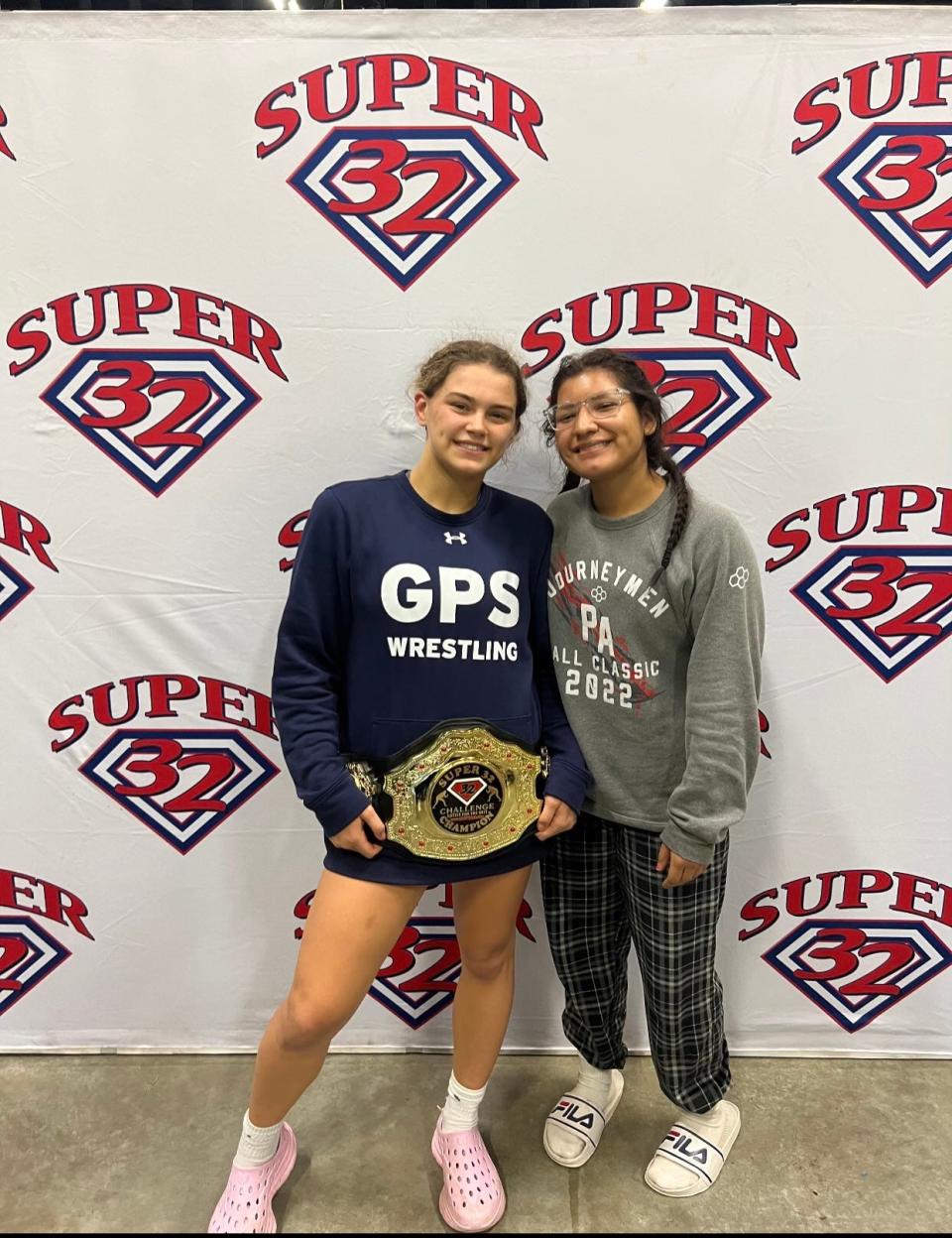 Pleasantville junior Adriana Palumbo poses for a photo with GPS Wrestling teammate Lauren Garcia of White Plains following her 155-pound title win at the 2023 Super 32