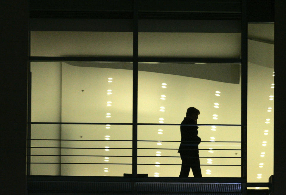 File - In this Tuesday, Nov. 22, 2005 file photo, newly elected German Chancellor Angela Merkel seen as a silhouette as she phones in her office after the handing-over ceremony at the chancellery in Berlin, Germany. Angela Merkel will leave office in the coming months with her popularity intact, despite her party’s dismal election result. (AP Photo/Markus Schreiber, File)