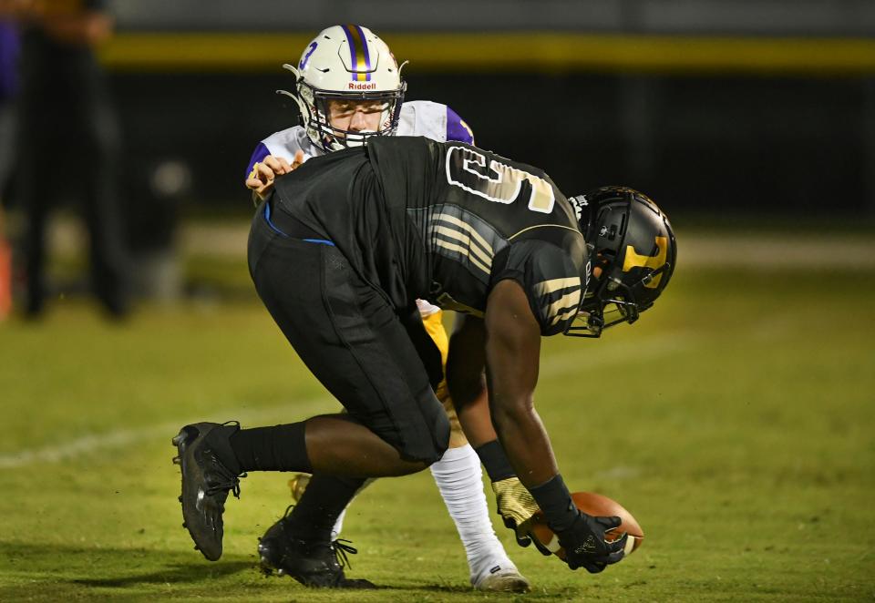 Treasure Coast High School's Corey McIntyre Jr. (center) goes after a loose ball after sacking Fort Pierce Central quarterback Nick Halliday during the first quarter of their District 6-8A opener on Friday, Oct. 1, 2021, at the South County Regional Stadium in Port St. Lucie.