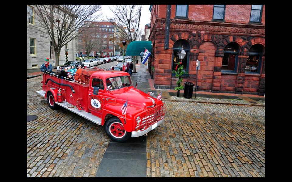 Riders enjoy a spin through the historic district during the Holiday Stroll held in downtown New Bedford in this Standard-Times file photo.