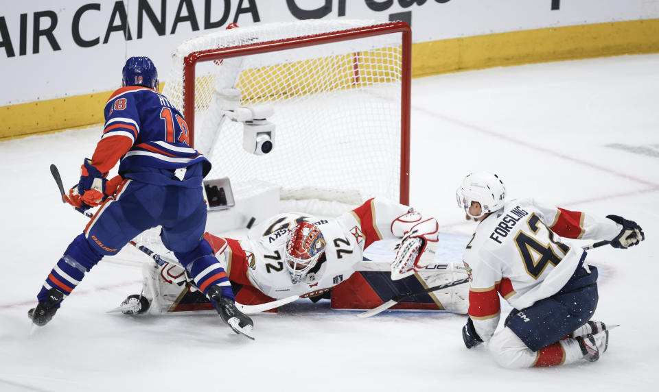 Florida Panthers goalie Sergei Bobrovsky (72) is scored on by Edmonton Oilers' Zach Hyman (18) as Gustav Forsling (42) watches during the second period of Game 6 of the NHL hockey Stanley Cup Final, Friday, June 21, 2024, in Edmonton, Alberta. (Jeff McIntosh/The Canadian Press via AP)