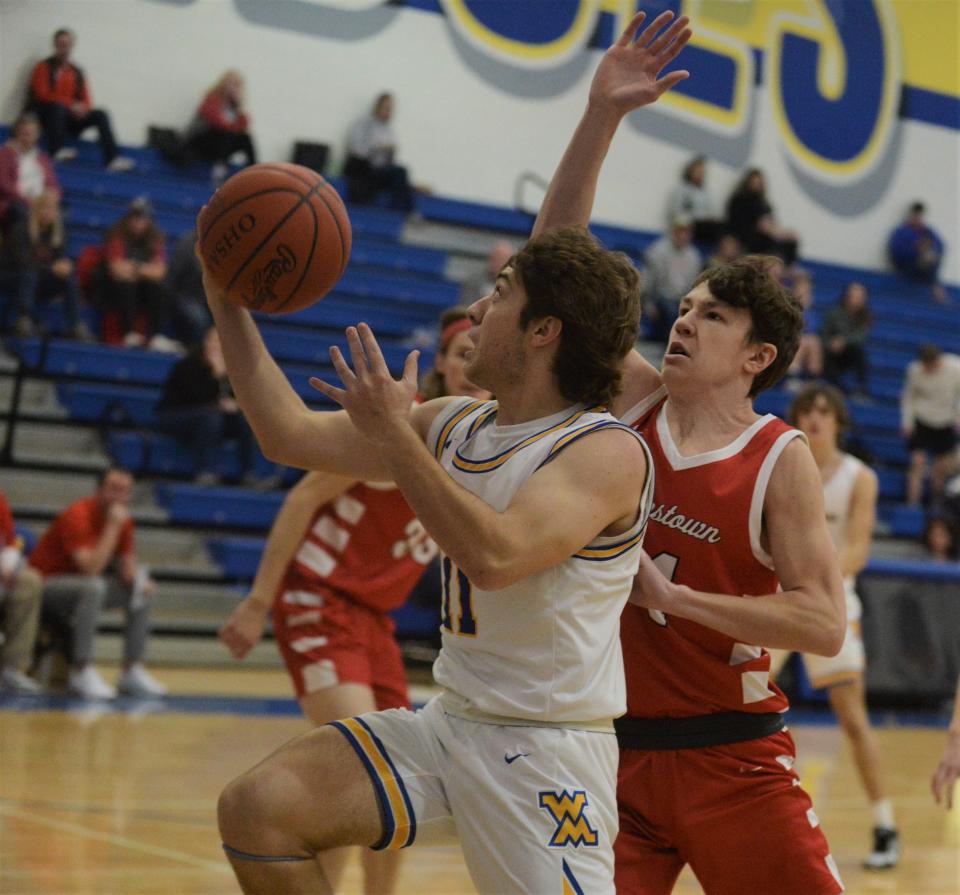 West Muskingum's Jack Porter goes up for a layup against Johnstown's Kyle Siegfried in Friday's game. The Johnnies won 48-33.