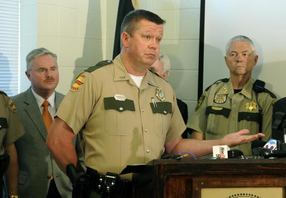 Tennessee Highway Patrol Trooper Randall Massengill discusses the results of an investigation into a fatal church bus crash Monday, April, 28, 2014, in Knoxville, Tenn. The investigation concluded a blown tire caused the October 2, 2013, accident in which the bus crossed the Interstate 40 median and crash into an SUV and tractor-trailer, killing eight people and injuring 14. (AP Photo/Knoxville News Sentinel, Michael Patrick)