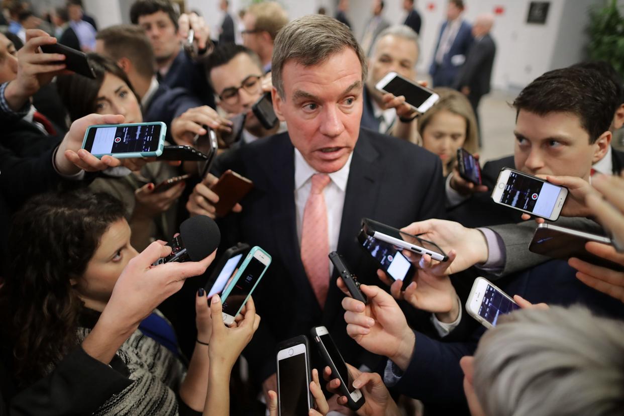 Reporters surround Senate intelligence committee ranking member Sen. Mark Warner as he heads for a policy luncheon in Washington on May 16.