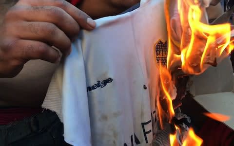 An attack on the Boca Juniors bus by rival fans which left players suffering cuts from broken glass and feeling the effects of tear gas has led to the postponement of the second leg of their Copa Libertadores final at River Plate.