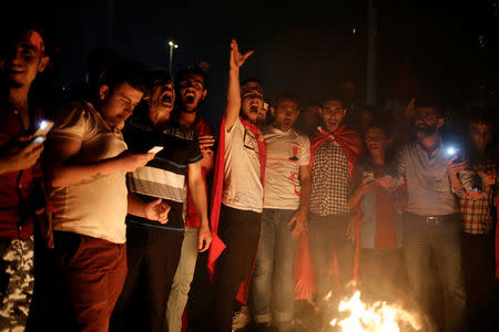 Supporters of Turkish President Tayyip Erdogan shout slogans over a burning effigy of U.S.-based cleric Fethullah Gulen during a pro-government demonstration on Taksim Square in Istanbul, Turkey, July 18, 2016. REUTERS/Alkis Konstantinidis