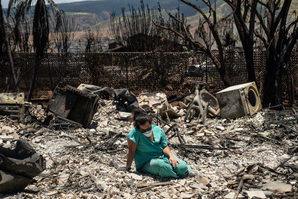 Sarah Salmonese sits where her apartment once stood in Lahaina, Maui, Hawaii, two days after it was devastated by wildfire, on Aug. 11.<span class="copyright">Go Nakamura—The New York Times/Redux</span>