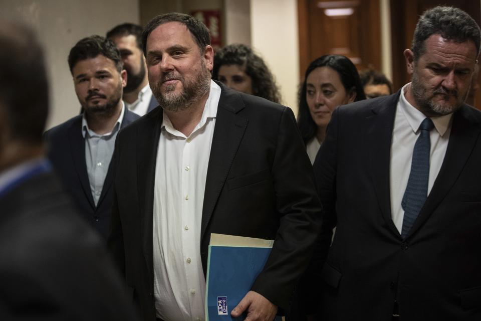 The leader of the Catalonian ERC party Oriol Junqueras, centre, leaves after collecting his credentials at the Spanish parliament in Madrid, Spain, Monday, May 20, 2019. Junqueras and three other high-profile separatists won seats in the Lower Chamber, while Raul Romeva won a seat in the Senate. The five, along with other defendants, are being held in pre-trial jail. They face several years in prison if found guilty of rebellion. (AP Photo/Bernat Armangue)