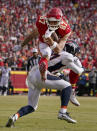 Kansas City Chiefs tight end Travis Kelce (87) leaps over Denver Broncos cornerback Damarri Mathis after catching a pass during the first half of an NFL football game Sunday, Jan. 1, 2023, in Kansas City, Mo. (AP Photo/Ed Zurga)