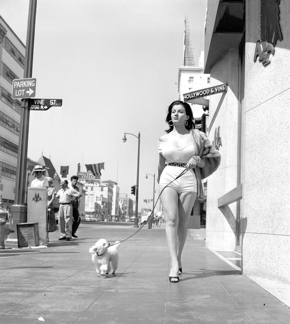 In 1953, the former Miss Texas paraded around Hollywood Boulevard for a series of portraits by Earl Leaf — accompanied by her poodle, Fifi. Bradshaw became better known for the photo series than for her acting work a few uncredited parts in features and the role of Redhead in 1957’s She Devil.