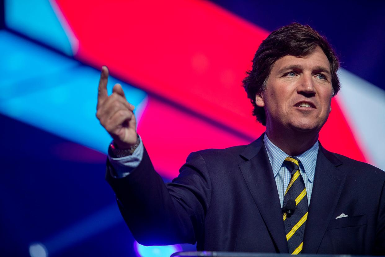 Tucker Carlson speaks during the first day of the America Fest 2021 hosted by Turning Point USA on Saturday, Dec. 18, 2021, in Phoenix. 