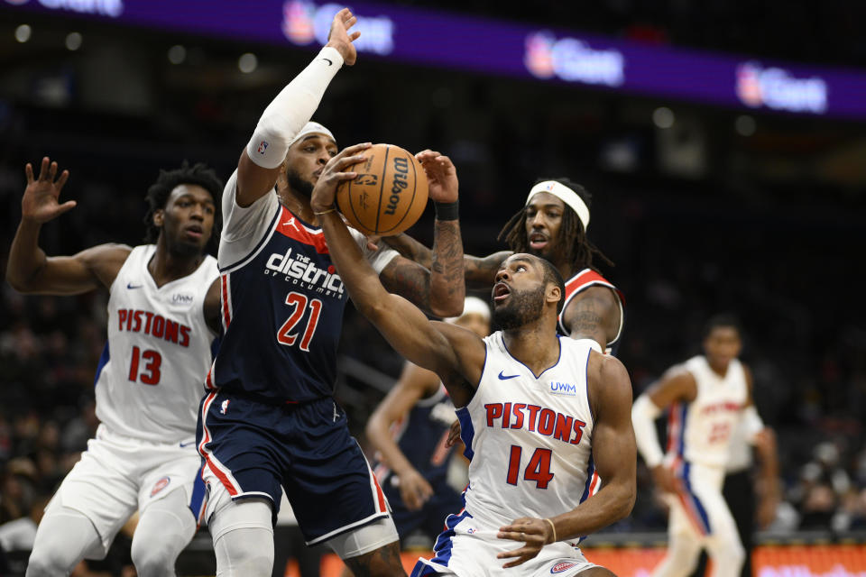 Detroit Pistons guard Alec Burks (14) goes to the basket against Washington Wizards center Daniel Gafford (21) during the first half of an NBA basketball game, Monday, Jan. 15, 2024, in Washington. Pistons center James Wiseman (13) watches the play. (AP Photo/Nick Wass)