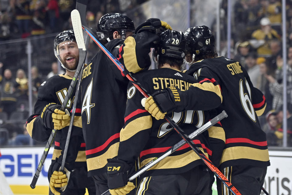 Vegas Golden Knights defenseman Alex Pietrangelo, left, and teammates celebrate after a goal against the Nashville Predators during the second period of an NHL hockey game Saturday, Dec. 31, 2022, in Las Vegas. (AP Photo/David Becker)