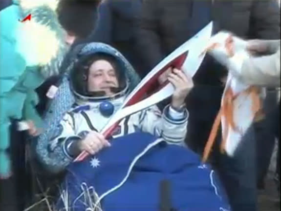 Russian cosmonaut Fyodor Yurchikhin holds the Olympic torch for the 2014 Winter Games in Sochi, Russia after landing back on Earth in Kazakhstan Nov. 10, 2013 on a Soyuz TMA-09M spacecraft with crewmates Karen Nyberg of NASA and Luca Parmitano