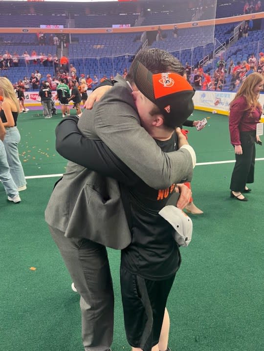 Bandits head coach John Tavares and ball boy Brett Swenson embrace after the team’s NLL title win in June 2023.