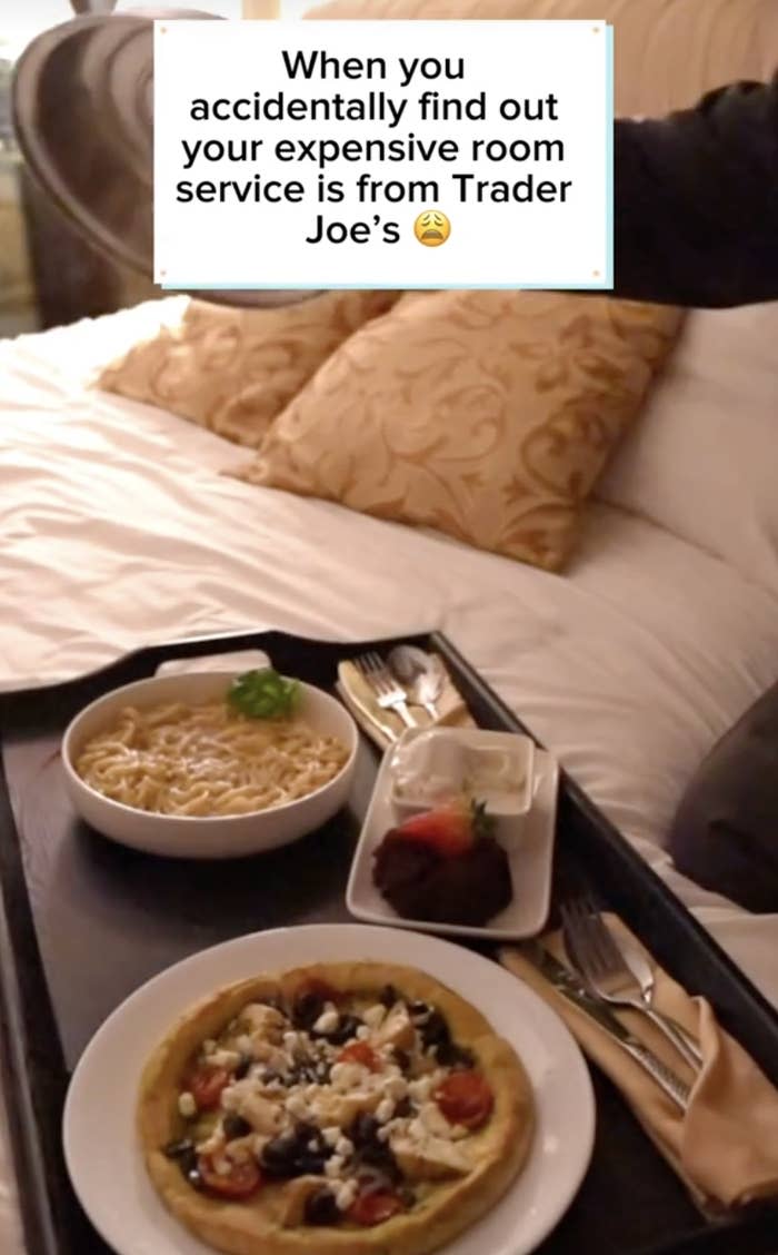 Text overlaid on image of room service food reads: "When you accidentally find out your expensive room service is from Trader Joe's"