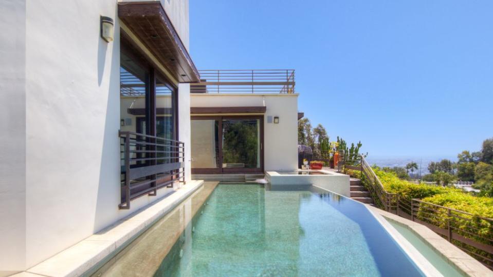 The property’s infinity-edged pool was painstakingly built onto a hillside. - Credit: Charmaine David Photography