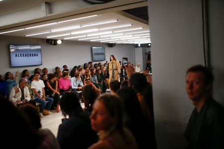 Members of the public watch models present creations at the Alexa Chung public catwalk show during London Fashion Week in London