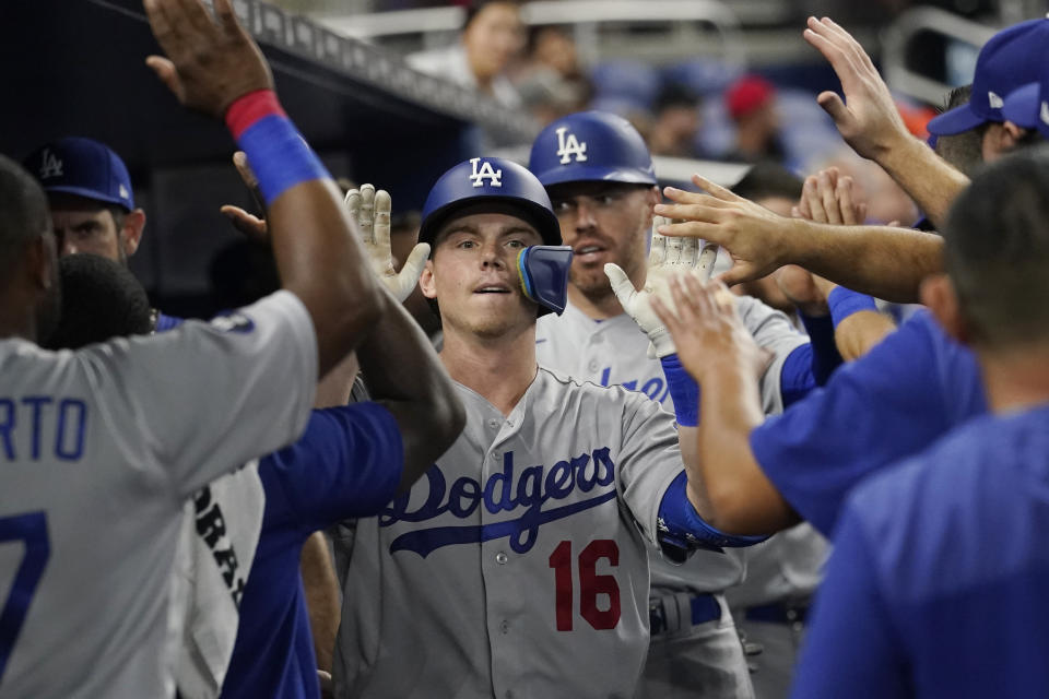 Los Angeles Dodgers' Will Smith (16) is congratulated by his teammates after hitting a home run in the third inning of a baseball game against the Miami Marlins, Monday, Aug. 29, 2022, in Miami. (AP Photo/Marta Lavandier)