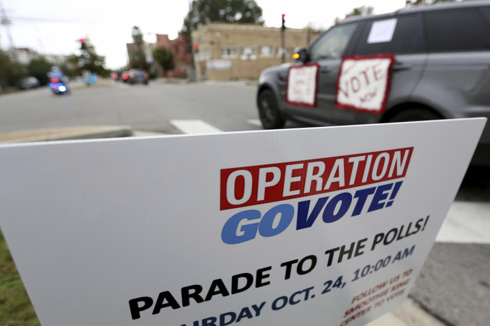 People participate in a "Parade to the Polls" event, organized by Operation Go Vote!, a collaborative of African American civic and social organizations, in New Orleans, Saturday, Oct. 24, 2020. In the best of times, it’s a massive logistical challenge to get millions out to vote. In 2020, the difficulty has been dramatically compounded: by fear of the coronavirus, by complications and confusion over mail-in ballots, by palpable anxiety over the bitter divisions in the country. (AP Photo/Rusty Costanza)