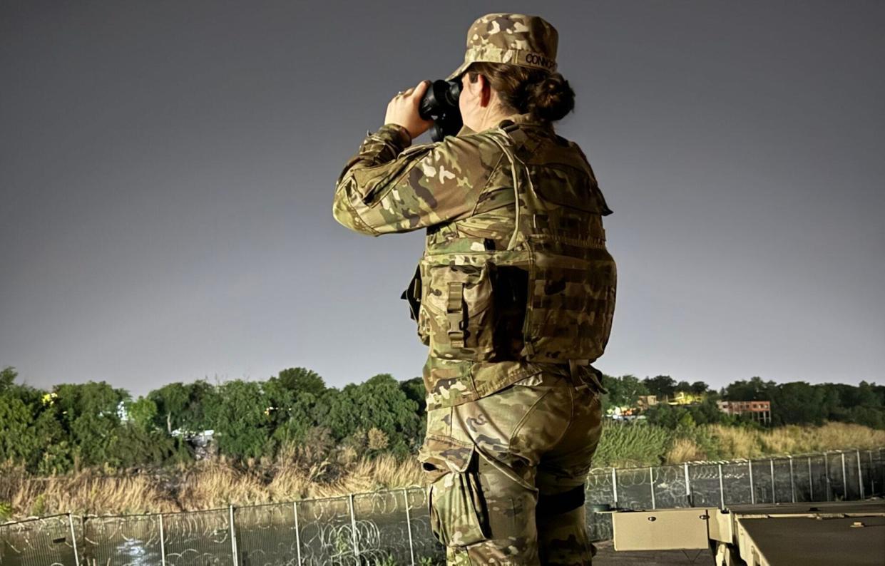 New Hampshire National Guard soldier Pfc. Macenzie Connors watches for illegal activity at an observation point in Eagle Pass, Texas.