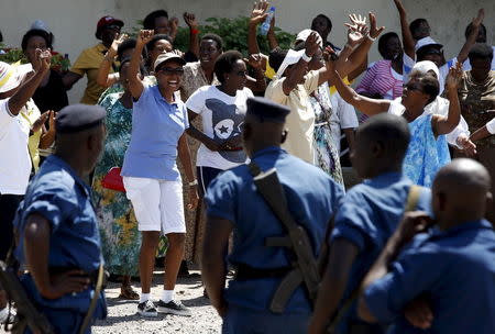 Women sing and dance in front of police during a protest by women against president Pierre Nkurunziza in Bujumbura, Burundi, May 10. 2015. REUTERS/Goran Tomasevic