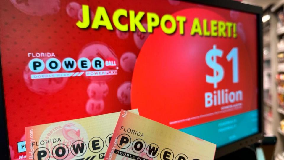 PHOTO: Powerball tickets are shown in front of a screen displaying the estimated jackpot, April 3, 2024, in Surfside, Fla. (Wilfredo Lee/AP)