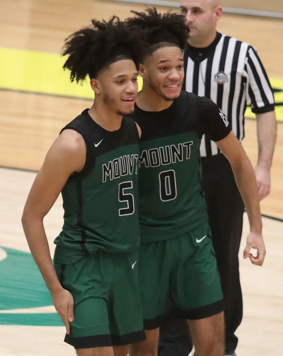 Green Knights Jayden (left) and Justin Lawrence come together as it appears their team will win in the opening round of the DIAA state high school tournament, Tuesday, Feb. 27, 2024 at Odessa.