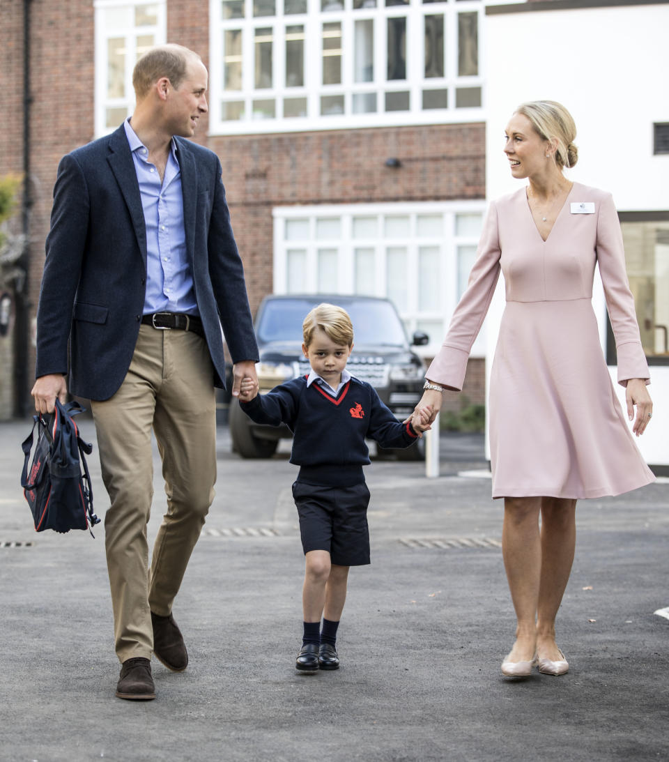 Britain's Prince George (C) accompanied by Britain's Prince William (L), Duke of Cambridge arrives for his first day of school at Thomas's school where he is met by Helen Haslem (R) head of the lower school on September 7, 2017 in southwest London. / AFP PHOTO / POOL / RICHARD POHLE        (Photo credit should read RICHARD POHLE/AFP/Getty Images)